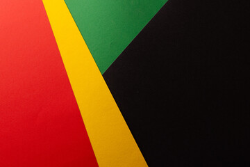 Green, yellow and red papers with copy space on black background