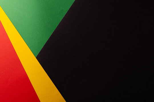 Green, yellow and red papers with copy space on black background