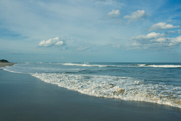 Beautiful seascape with waves tides on the sandy beach and blue sky. Nature Landscape scenery beauty