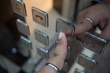 Man finger press on open sign button on elevator. Close up - obrazy, fototapety, plakaty