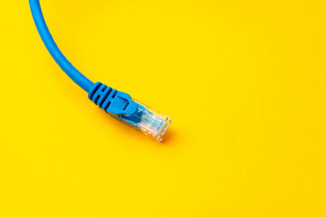 Network cable on yellow background studio shot