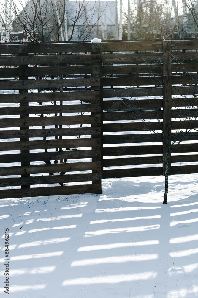 Canvas Prints shadow from a wooden fence on the snow in winter