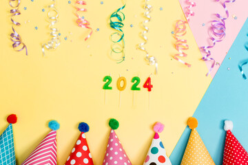 2024 party theme with with hats and streamers on a vibrant background
