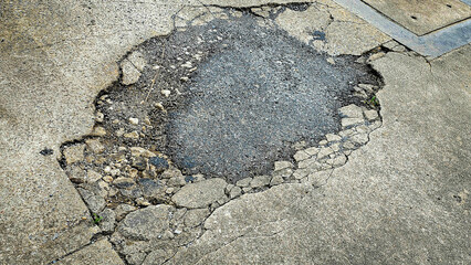 A picture of potholes at damage road, Damaged asphalt pavement road with potholes. Potholes on a...