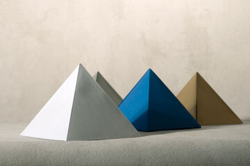 Conceptual still life with paper pyramids.