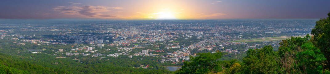 Fototapeta na wymiar Panorama view of Chiangmai Chiang Mai city taken from Doi Suthep Mountains. Lovely views of the Old city at Sunset Sunrise lovely tropical mountains and beautiful nature in the foreground