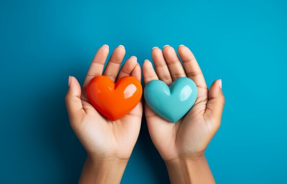 Generative AI image of multicultural hands holding colored hearts over blue background