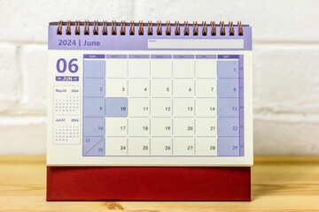 Desk calendar for June 2024 on the table with copy space.