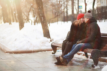 Young couple walking through the winter - obrazy, fototapety, plakaty