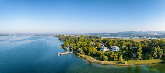 Luftbild-Panorama von der Halbinsel Mettnau im westlichen Bodensee von der Morgensonne angestrahlt...
