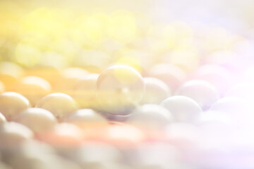 Abstract background with lens flare and pearls. A string of pearls. Artificial garland of pearls.