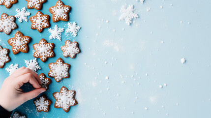Gingerbread cookies blue confetti and hand on white background