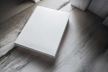 Foto op Aluminium hardcover books with blank cover isolated on a wooden table © Rojo