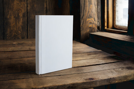 hardcover books with blank cover isolated on a wooden table