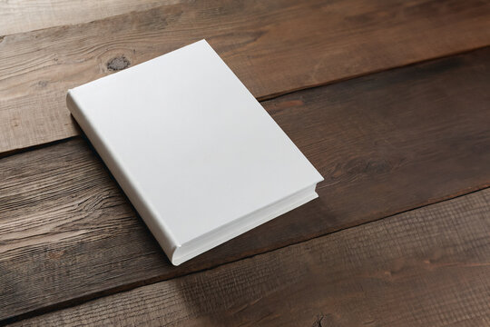 hardcover books with blank cover isolated on a wooden table