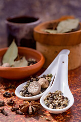 Spices star anise, nutmeg in isolated ceramic bowl