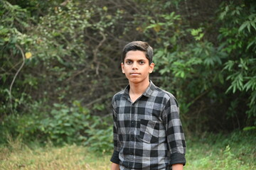 Naklejka na ściany i meble close up of young Indian boy in jungle 