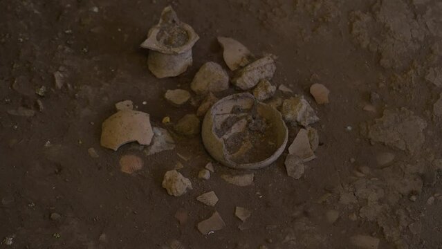 Archeological excavation. Archeological Digging Site. Newly discovered ancient civilization cultural artifact. Dig up an ancient clay artifact in soil. Broken vase, Clay pottery, Earthenware, Ceramic