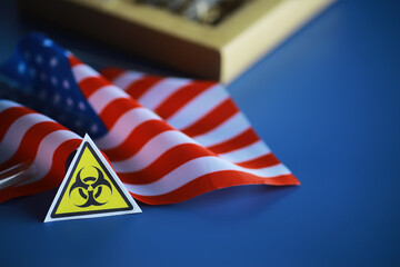 American flag and biohazard sign. The concept of American biolabs and research centers.