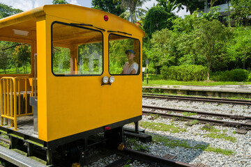 Woman sitting in the yellow retro train cart