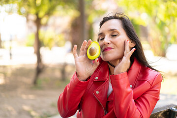 Middle aged woman holding an avocado