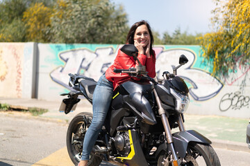 Middle aged woman with a motorcycle at outdoors