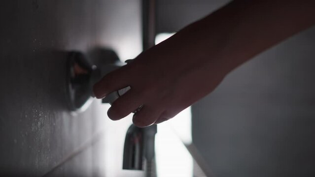 Woman unscrews water in shower to pressure to wash