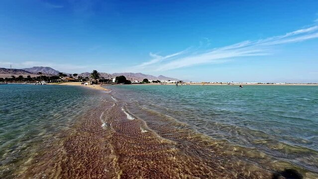 People parasailing on the coastline of Dahab, sunny day in Egypt, Africa