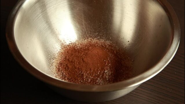 Mixing dry ingredients for shortbread dough with pastry whisk. 