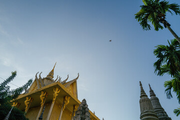 Bird flying over the roof of the Wat Langka temple in Phnom Penh