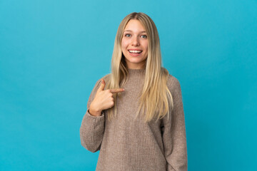 Fototapeta premium Young blonde woman isolated on blue background with surprise facial expression