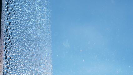 Condensation on window glass in frosty winter weather. Background in the form of small drops on the...
