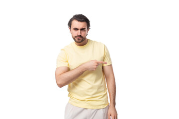 well-groomed young caucasian man with an unshaven beard and mustache against the background with...