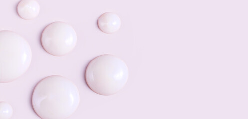 cosmetic smears drops of cream texture on pastel pink background