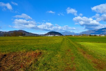 View of field at Sorsko polje and hills Jost and Smarjetna gora in Gorenjska, Slovenia