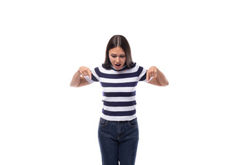 young european lady with black even hair dressed in a striped t-shirt points with her index finger for ideas and news