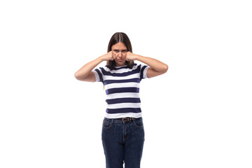 offended young brunette caucasian woman with light makeup dressed in a striped t-shirt and jeans