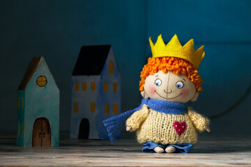Close up of textile doll-boy a little prince at blue background.