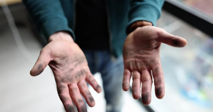 Man shaking off his dirty black hands in dust closeup 4k movie slow motion. Hygiene hand washing concept