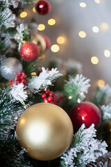Decorated Christmas, New year room with beautiful snow-covered fir tree and golden ball on lights background