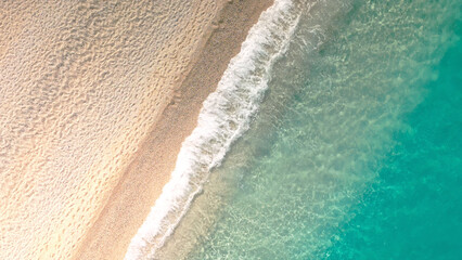 Diagonal aerial view of tropical sandy beach with turquoise trasparent crystal clear sea water
