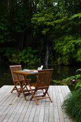 Fototapeta na wymiar Table and chairs in the tropical surroundings
