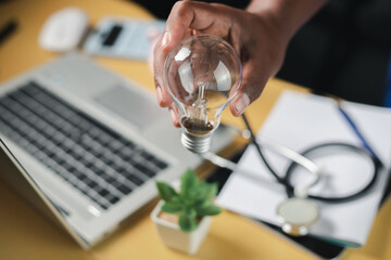 businessman holding light bulb and brain graphic inside It represents the imagination of business networking technology innovation.	