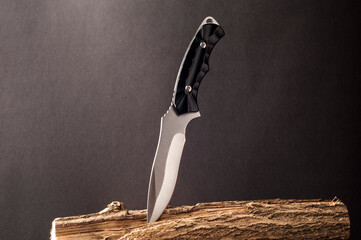 sharp steel knife on a dark background