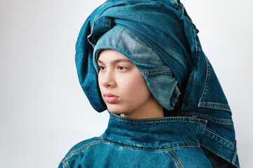 Fototapeta premium Portrait of a girl wearing a turban-like denim headdress. Jeans clothes, total denim.