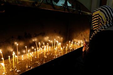 Faithful lighting candles in Transfiguration church, Chisinau, Moldova.