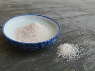 Himalayan pink salt on table wood background