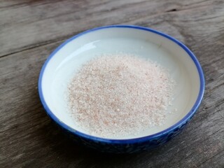 Himalayan pink salt on table wood background