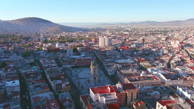 Mexico, Pachuca: Aerial view of capital city of Mexican state of Hidalgo at sunrise, Monumental Clock (Reloj Monumental de Pachuca) - landscape panorama of Latin America from above