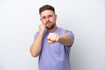 Young caucasian man isolated on white background with fighting gesture